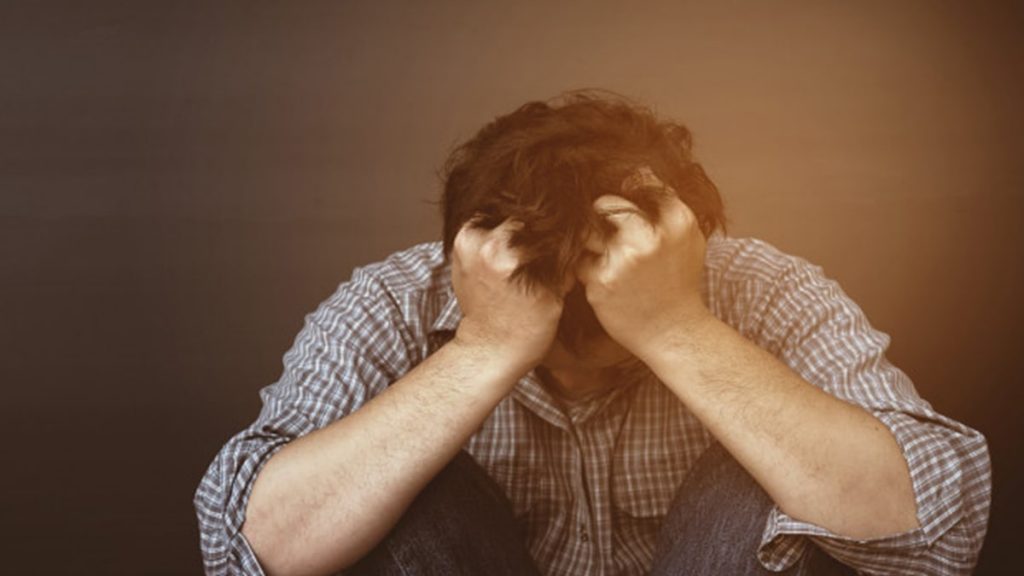 sad man sitting due to depression and sadness